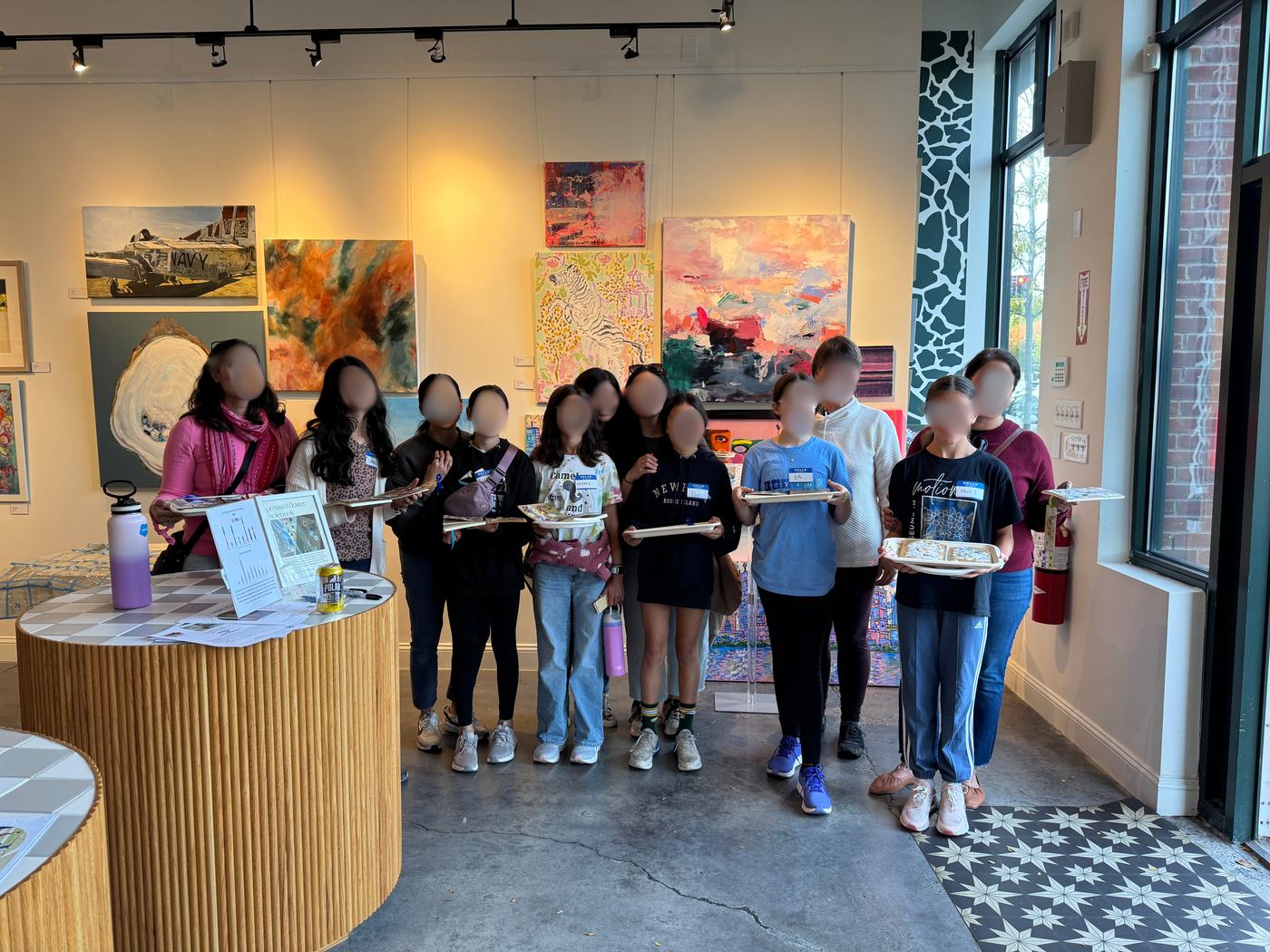 Kids holding pressed flower notebooks they made at the Grow Studio event